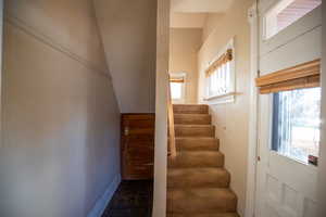 Stairway featuring plenty of natural light