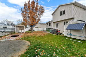 Fenced backyard with an outbuilding