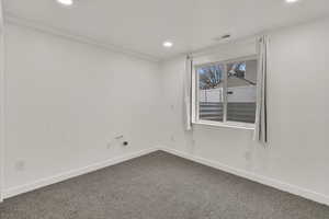 Carpeted spare room and recessed lighting