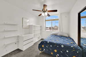 Carpeted bedroom with ceiling fan