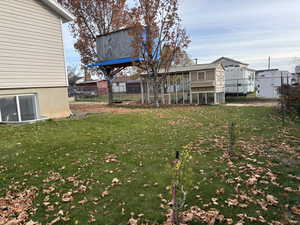 View of yard featuring exterior structure and an outbuilding