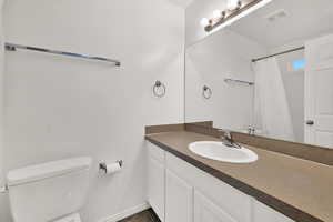 Bathroom featuring vanity and curtained shower
