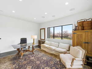 Office area featuring dark wood-type flooring and recessed lighting