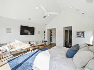 Primary Bedroom with high vaulted ceiling, ceiling fan, and wood finished floors