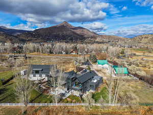 Aerial view of property's location with a mountain backdrop