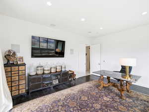 Office area featuring dark wood finished floors and recessed lighting