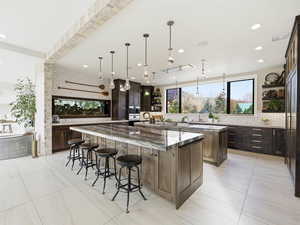Kitchen featuring open shelves, dark brown cabinets, tasteful backsplash, dark stone counters, and recessed lighting