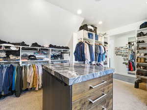 Spacious closet with light colored carpet