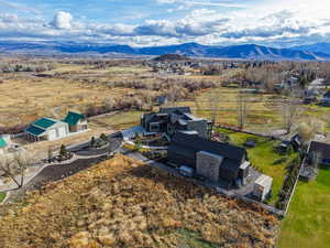 Aerial view of property and surrounding area with a mountainous background