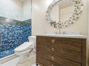 Bathroom with vanity and tiled shower
