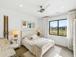 Bedroom with dark colored carpet, a ceiling fan, and recessed lighting