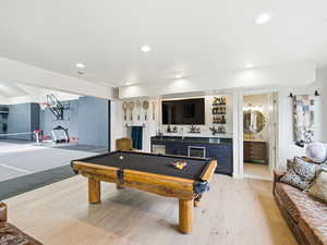 Rec room featuring a dry bar, light wood-style flooring, wine cooler, billiards, and recessed lighting