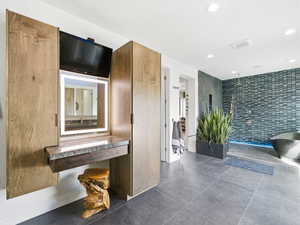Corridor featuring tile walls and recessed lighting
