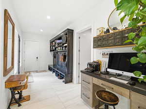 Hallway featuring light tile patterned floors and recessed lighting