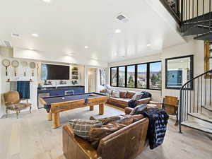 Game room with light wood-type flooring, billiards, wine cooler, and recessed lighting