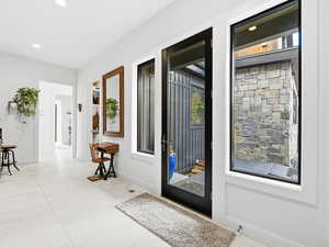 Entrance foyer featuring baseboards and recessed lighting