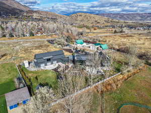 Aerial view of property and surrounding area with mountains