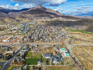 Aerial overview of property's location featuring mountains and nearby suburban area
