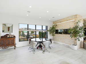 Dining area featuring brick wall and recessed lighting