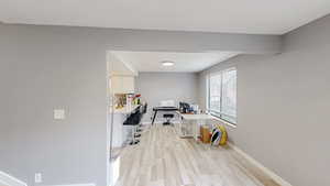 Office space featuring light wood-style floors and baseboards