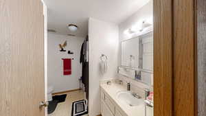 Bathroom featuring light floors, vanity, and a shower with curtain