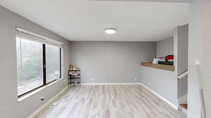 Spare room with light wood-type flooring and baseboards