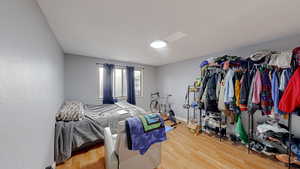 Bedroom with light wood-type flooring and baseboards
