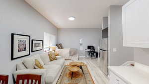 Living area with light wood-type flooring and a desk