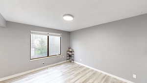Unfurnished room with baseboards and light wood finished floors