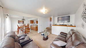 Living area featuring light tile patterned floors and stairs