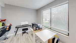 Home office featuring light wood finished floors and baseboards