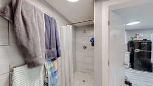 Full bath featuring a shower stall