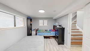 Bedroom with light wood-style floors and baseboards