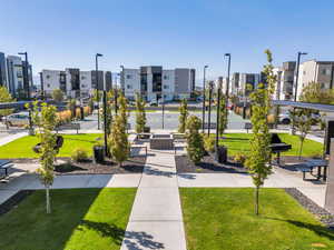 Surrounding community with a yard and a patio area