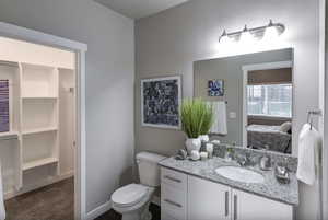Ensuite bathroom with vanity and walk-in closet.