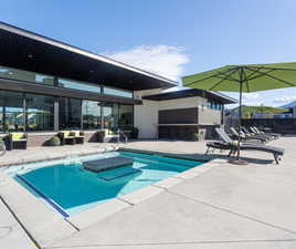 Community pool with a patio