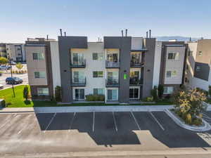 View of property with uncovered parking