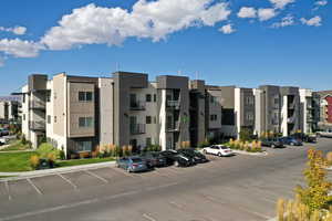 View of property with uncovered parking