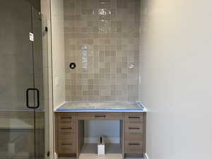 Bathroom with a shower stall and vanity