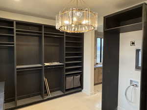 Walk in closet with a chandelier