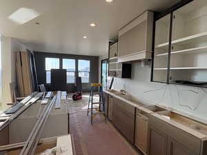 Kitchen with open shelves, recessed lighting, and range hood