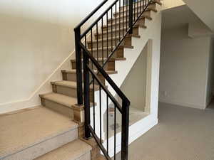 Staircase with baseboards and carpet floors