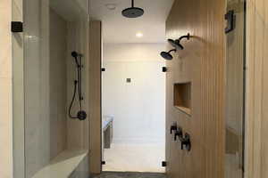 Full bathroom featuring walk in shower, vanity, recessed lighting, light tile patterned floors, and tile walls