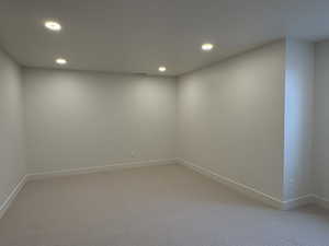 Spare room with recessed lighting and light carpet