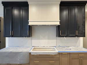 Kitchen featuring dark cabinets, light countertops, and electric stovetop