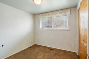 Unfurnished room featuring carpet flooring and baseboards