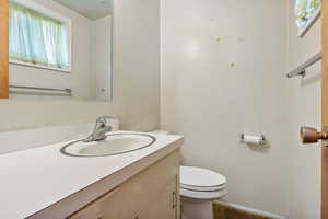 Half bathroom with vanity and toilet