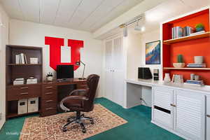 Office with dark colored carpet, rail lighting, and built in shelves