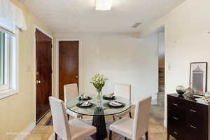 Dining space featuring wallpapered walls and baseboards