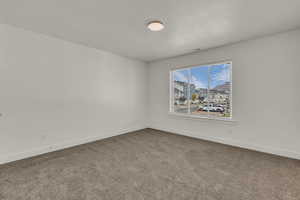 Empty room with carpet floors and baseboards